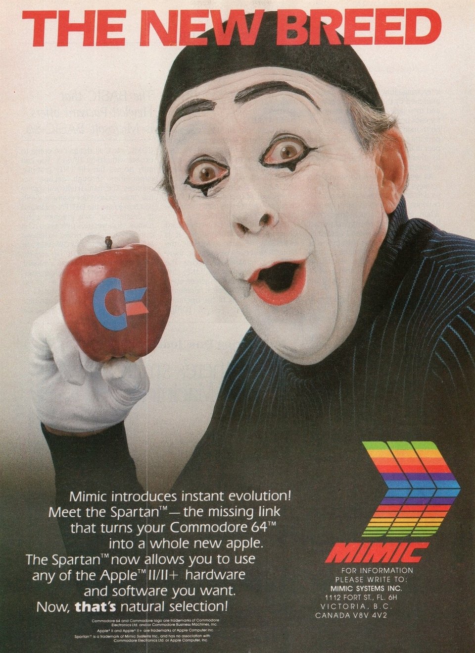 A mime, wide-eyed and mouth open in surprise. He his holding an apple in his hands with the Commodore logo on it.