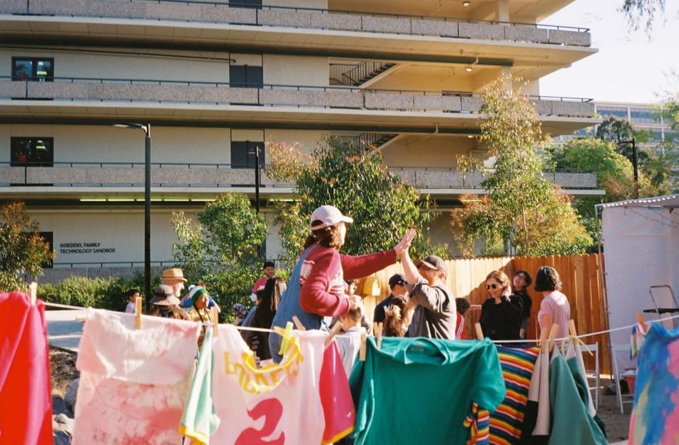 A young woman high fiving an audience member