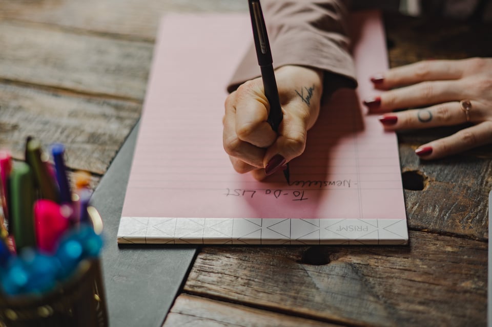 kate writing on a notebook
