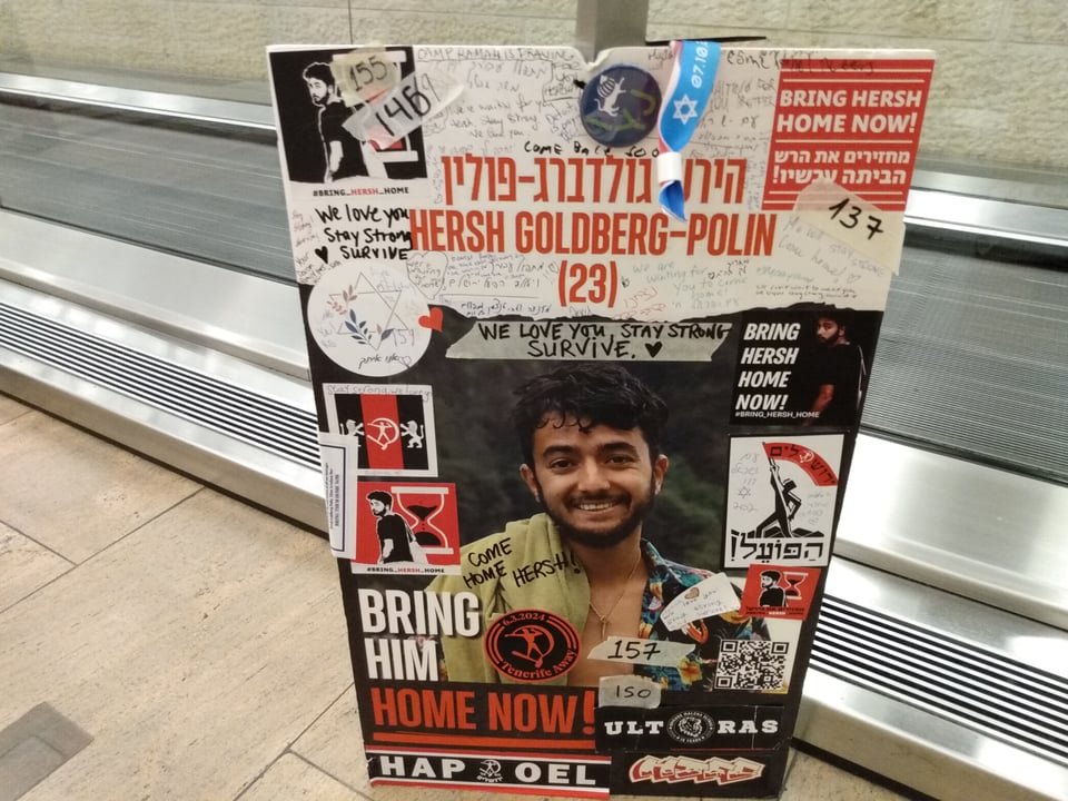 A BRING THEM HOME NOW sign of Hersh Goldberg-Polin at Ben Gurion Airport on March 17, 2024.