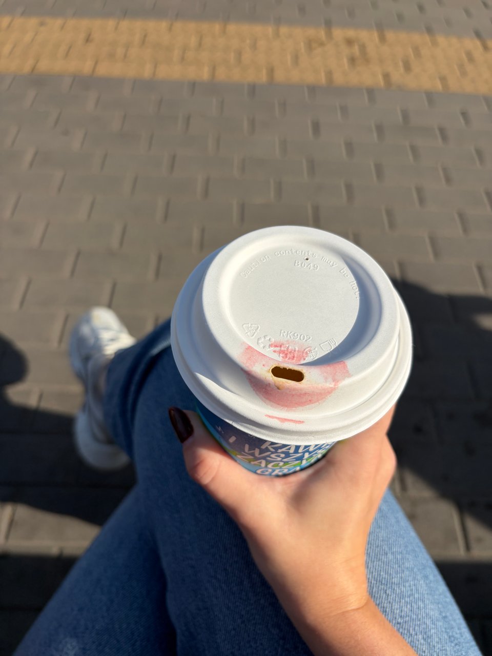 Takeout coffee cup with lipstick mark on top