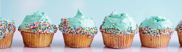a row of cupcakes with sprinkles