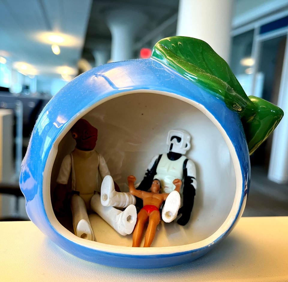 Admiral Ackbar, a stormtrooper and a lifeguard inside of a ceramic blue apple.