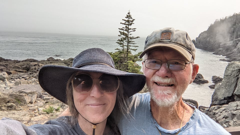 me with my dad's arm around my shoulder, on a cliff on the rocky Atlantic coast near Lubec ME