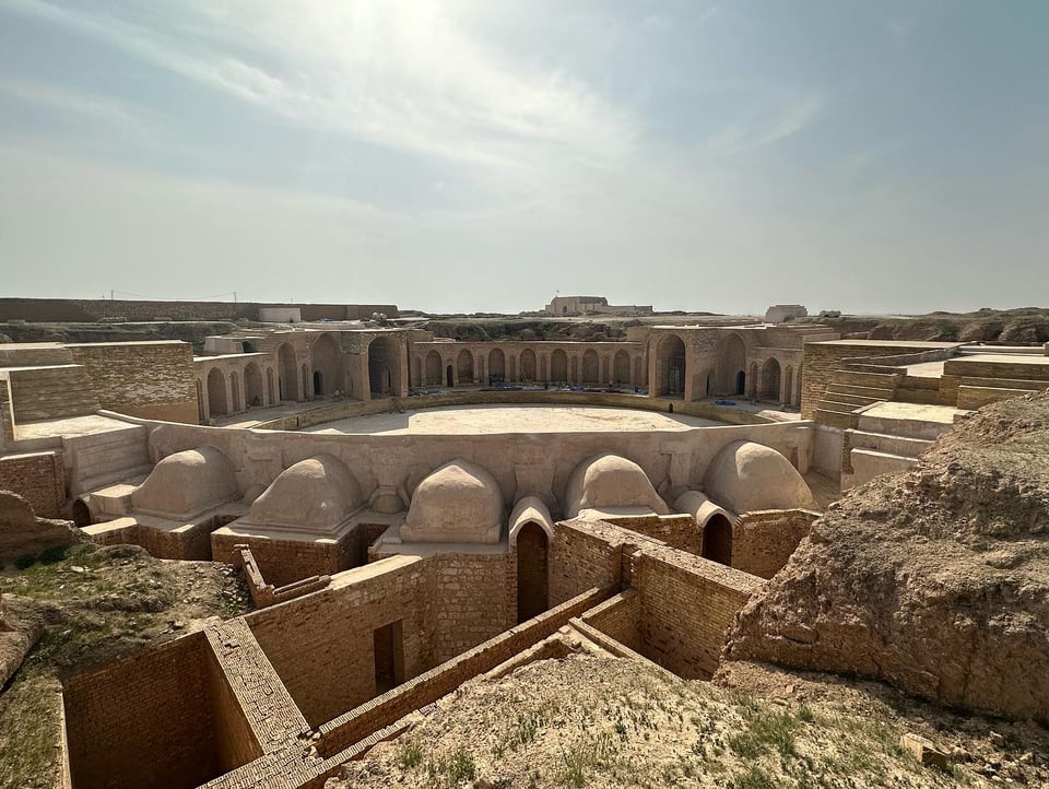 An image of brown stone ruins in a flat landscape