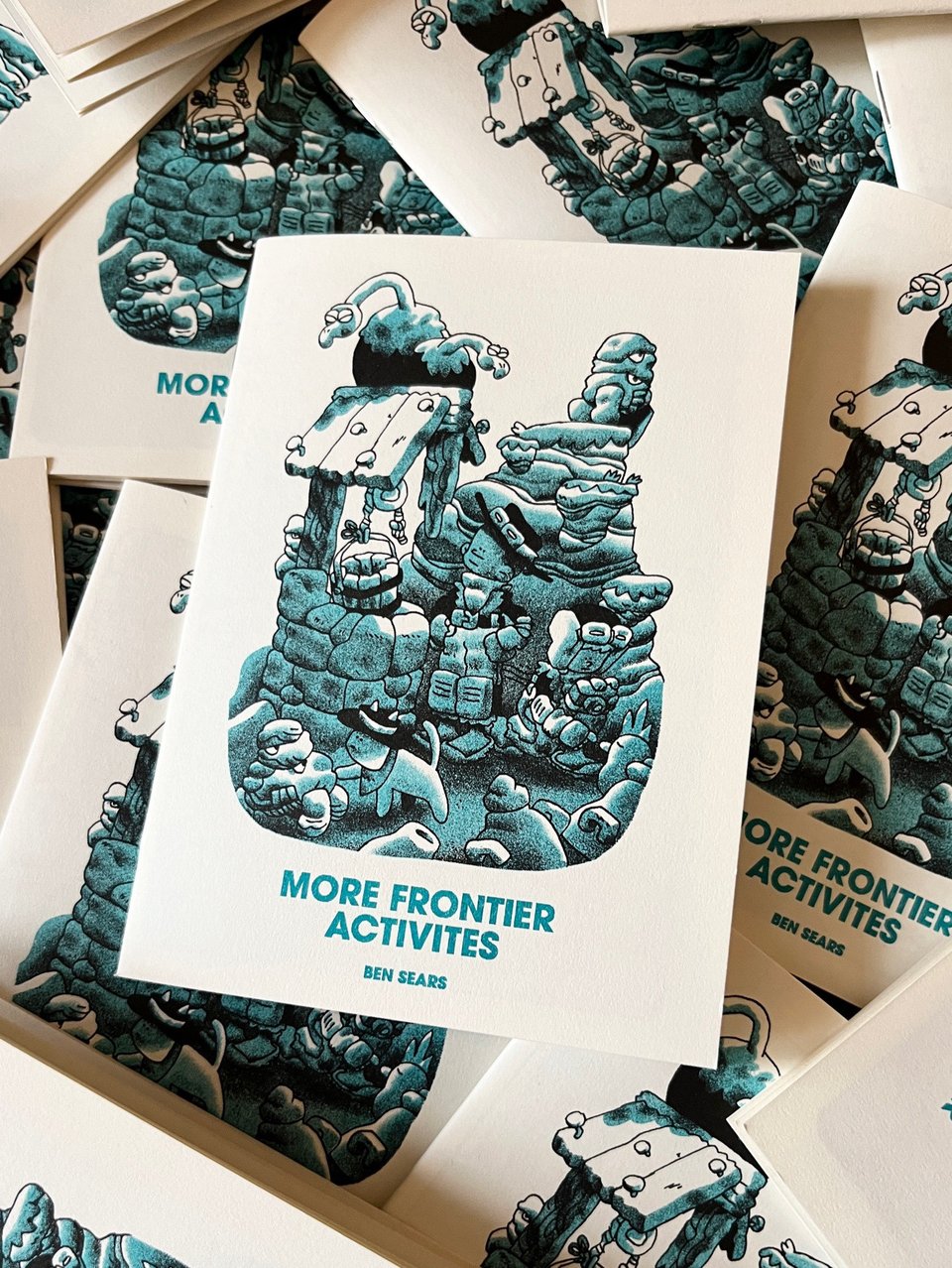 Picture of a zine called More Frontier Activities. The cover art depicts two kids and a cat in the desert investigating some ruins. There are vultures sitting on the rocks around them, and a couple of weird desert crabs.