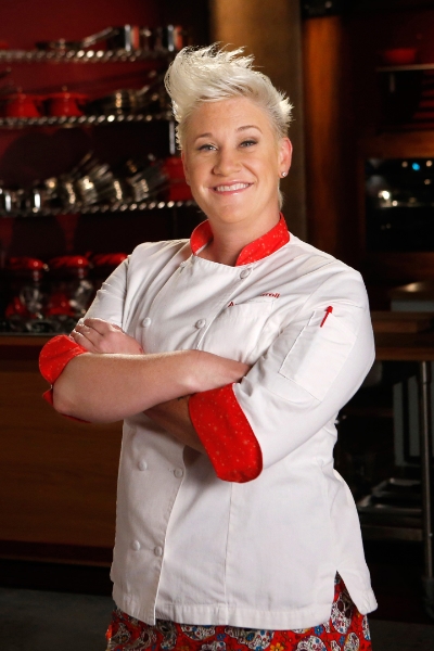 a woman in a chef's uniform with red accents