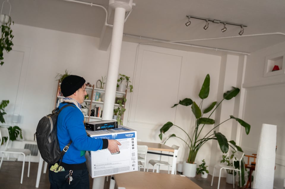 Dan carrying a printer box.