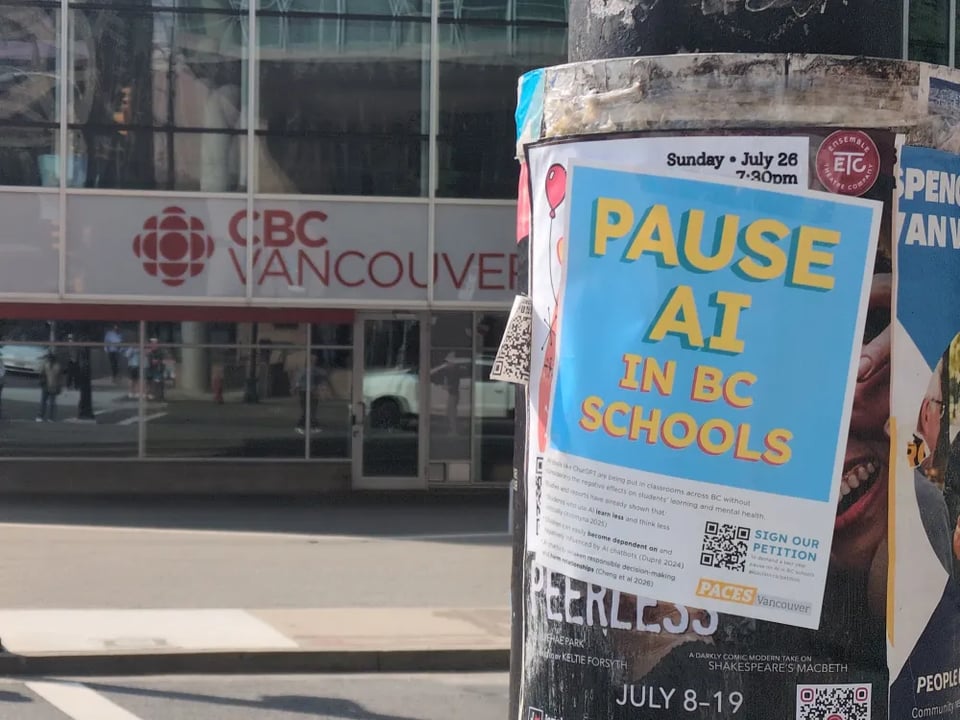 Photo of a poster on a streetlight. Poster reads "pause air in BC schools". In the background is an CBC Vancouver office.