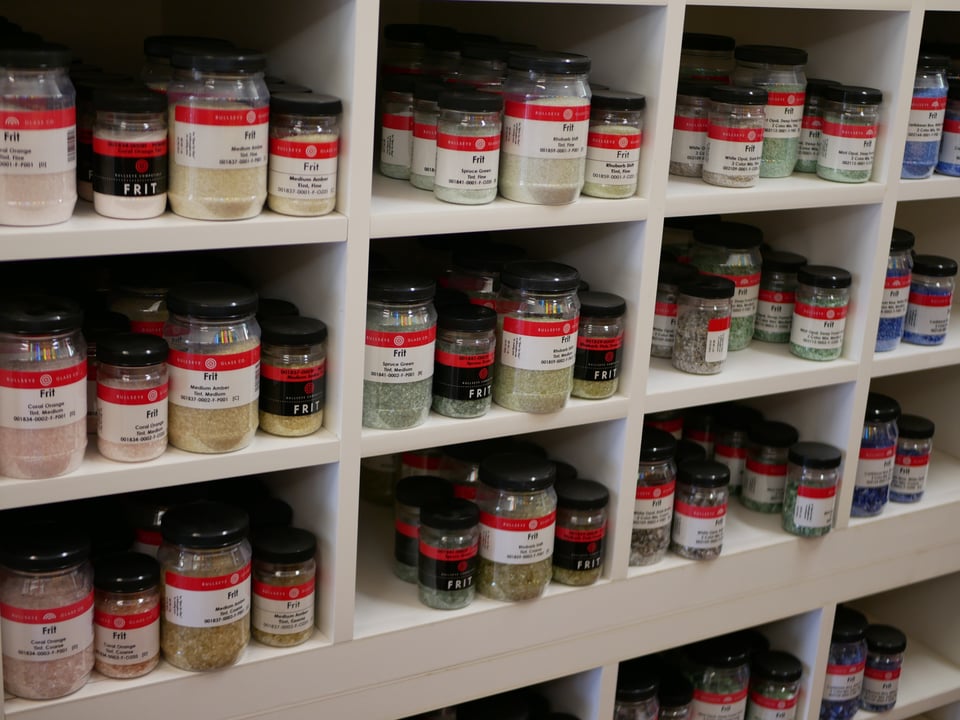shelving units crowded with jars of frit