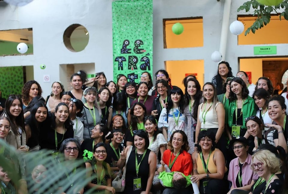 A large group of people posing for a photo in a courtyard