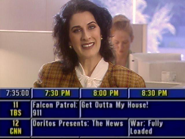 still from the short film "Channelvue," showing a corporate-looking TV channel CEO above the scrolling TV Guide Menu, including shows with titles like "Falcon Patrol: 911" and "Doritos Presents: The News"