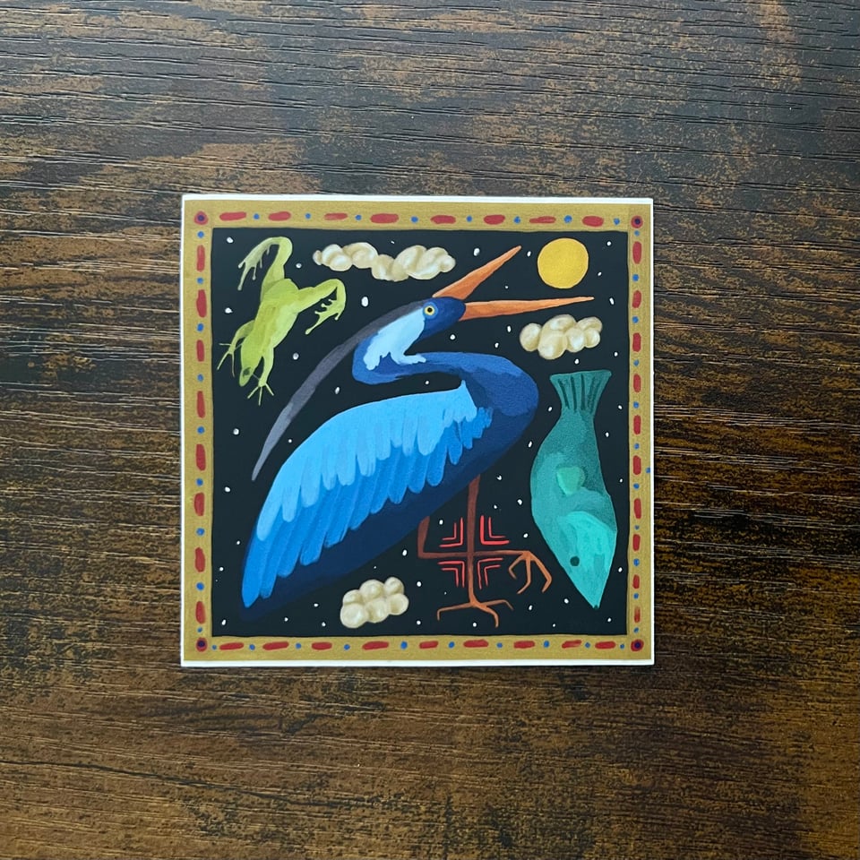 An illustrated scene of a blue heron with a frog and a fish in a celestial scene with stars and clouds with a black background. The heron’s legs are crossed and with them are angled lines forming a Taino symbol. The border is gold with red lines and blue dots.