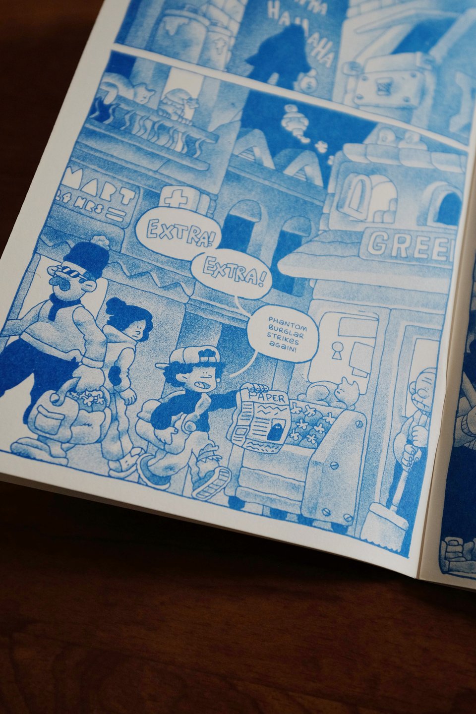 picture of the comic "young shadow: tunnel vision"  an early morning city street scene in which a kid is walking around selling newspapers