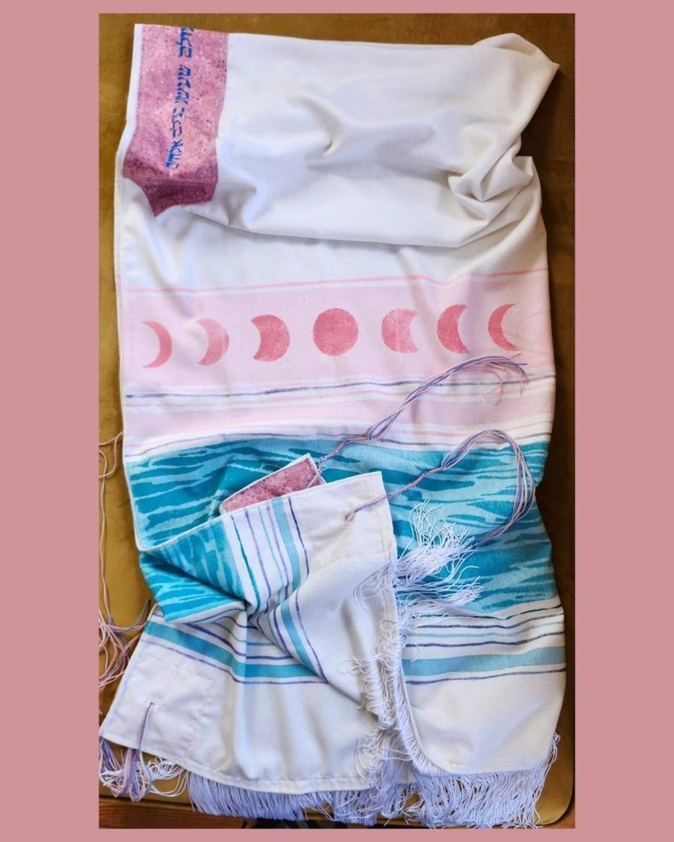 pink, blue, and white trans pride tallis. 