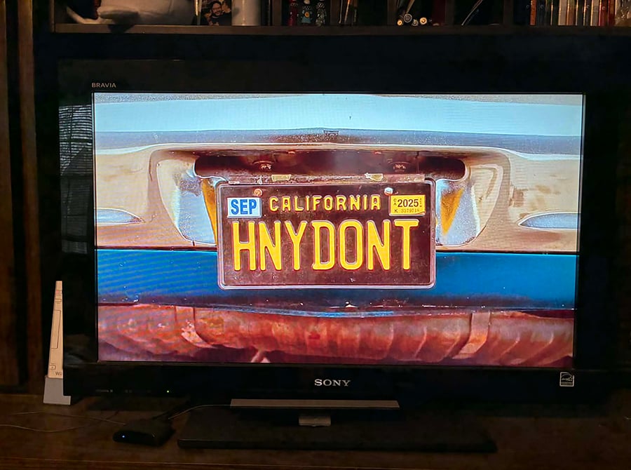 A photo of my TV, from when I was watching Honey Don't!, specifically of when the title came on screen. The title didn't exactly come on screen--it's a closeup of a license plate that reads HNYDONT.