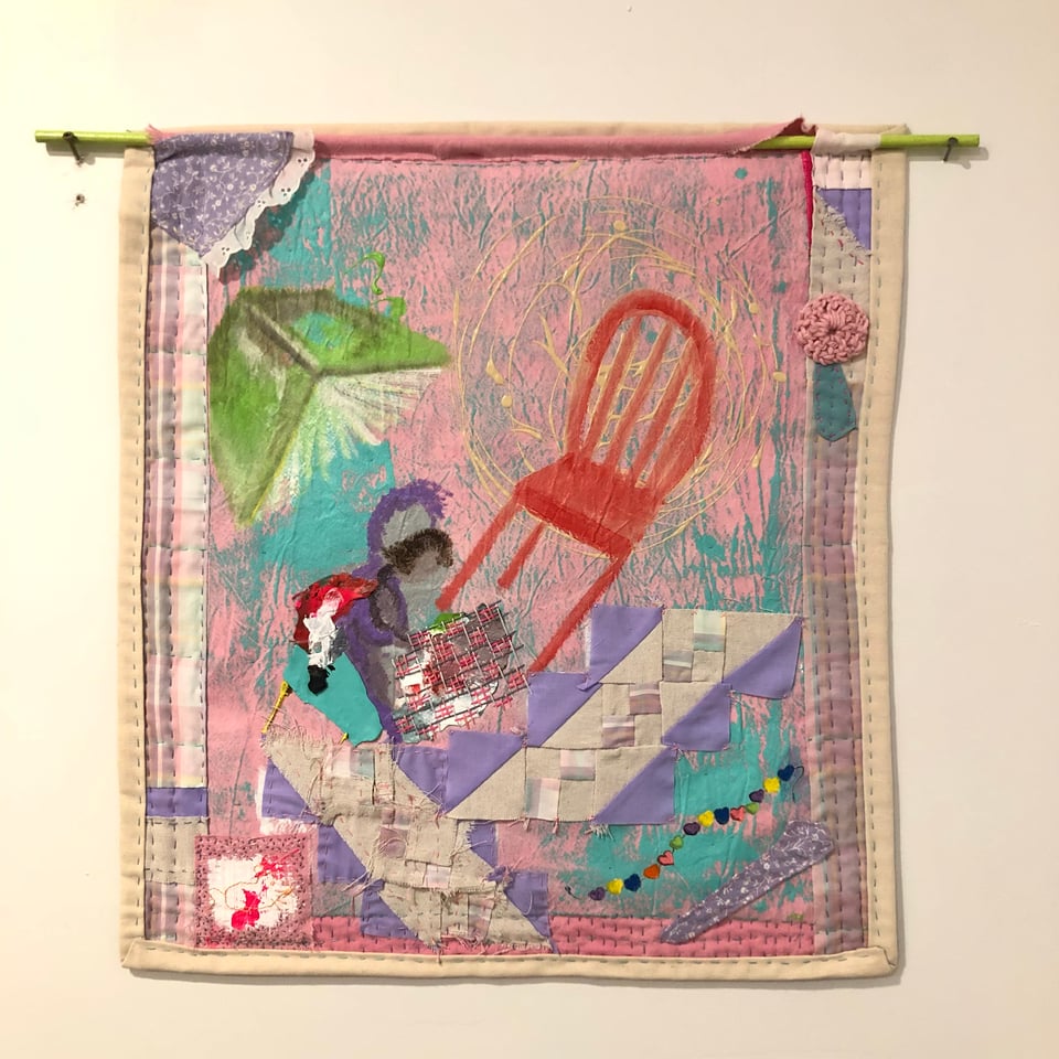 quilted painting of two figures reading with abstract elements of a red chair and flying book on the plane