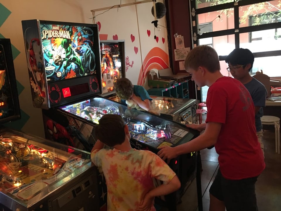 Children playing pinball.