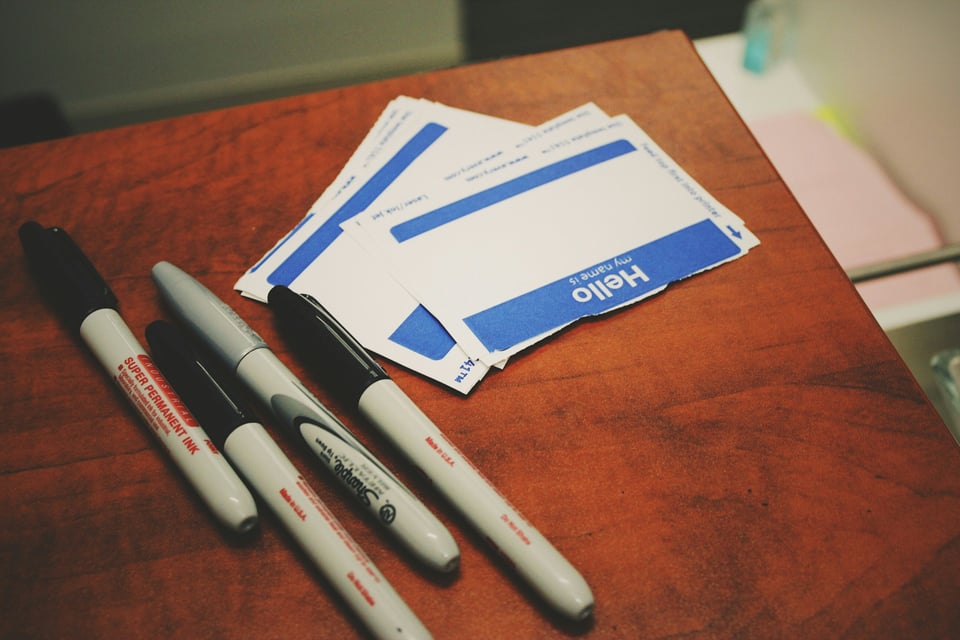 a desk with markers and name tags on it