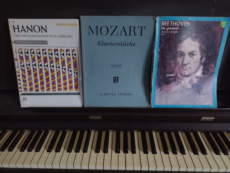 Piano with books of Hanon, Mozart, Beethoven