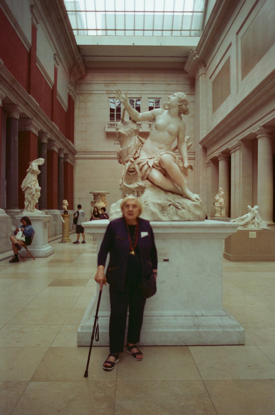 francesca stands in front of a statue at the Met