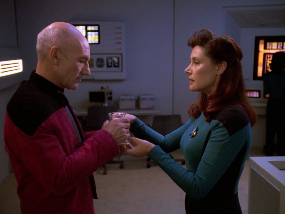 Commander Darren and Captain Picard are in the Astrometrics Lab. She is offering him a cup of tea, as he takes the cup from her hands.