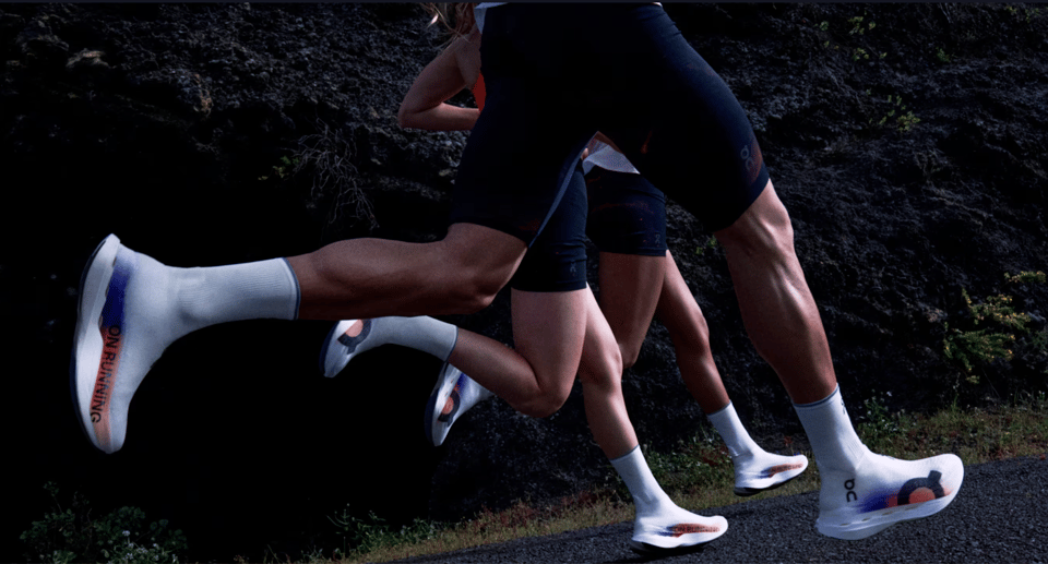 A group of runners using shoes made using LightSpray technology.