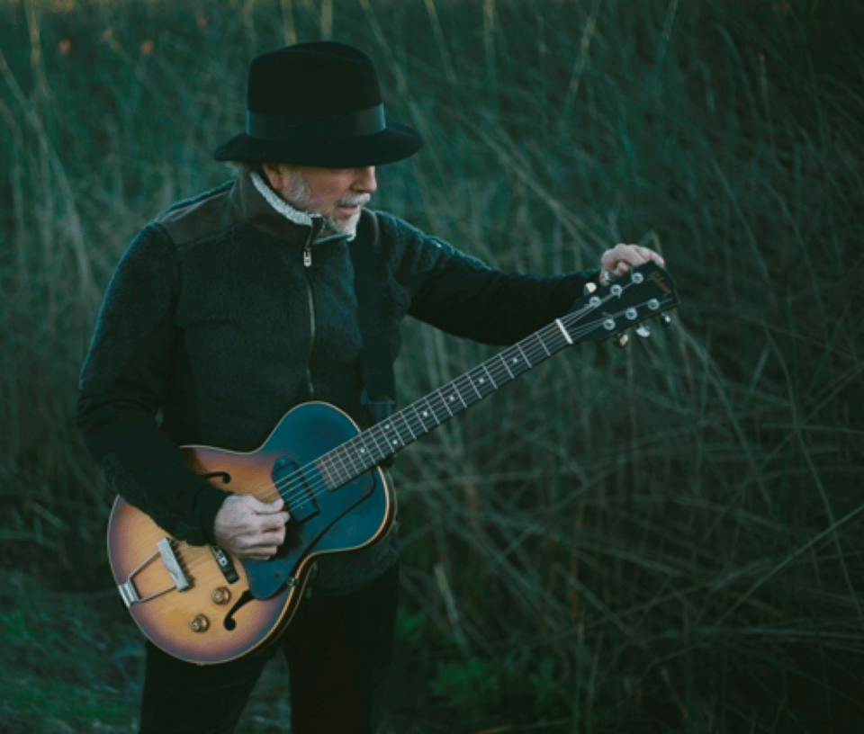 Roy Rogers tuning his guitar off-stage