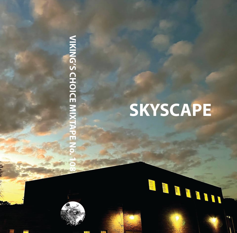 A building silhouette at dusk. Clouds.