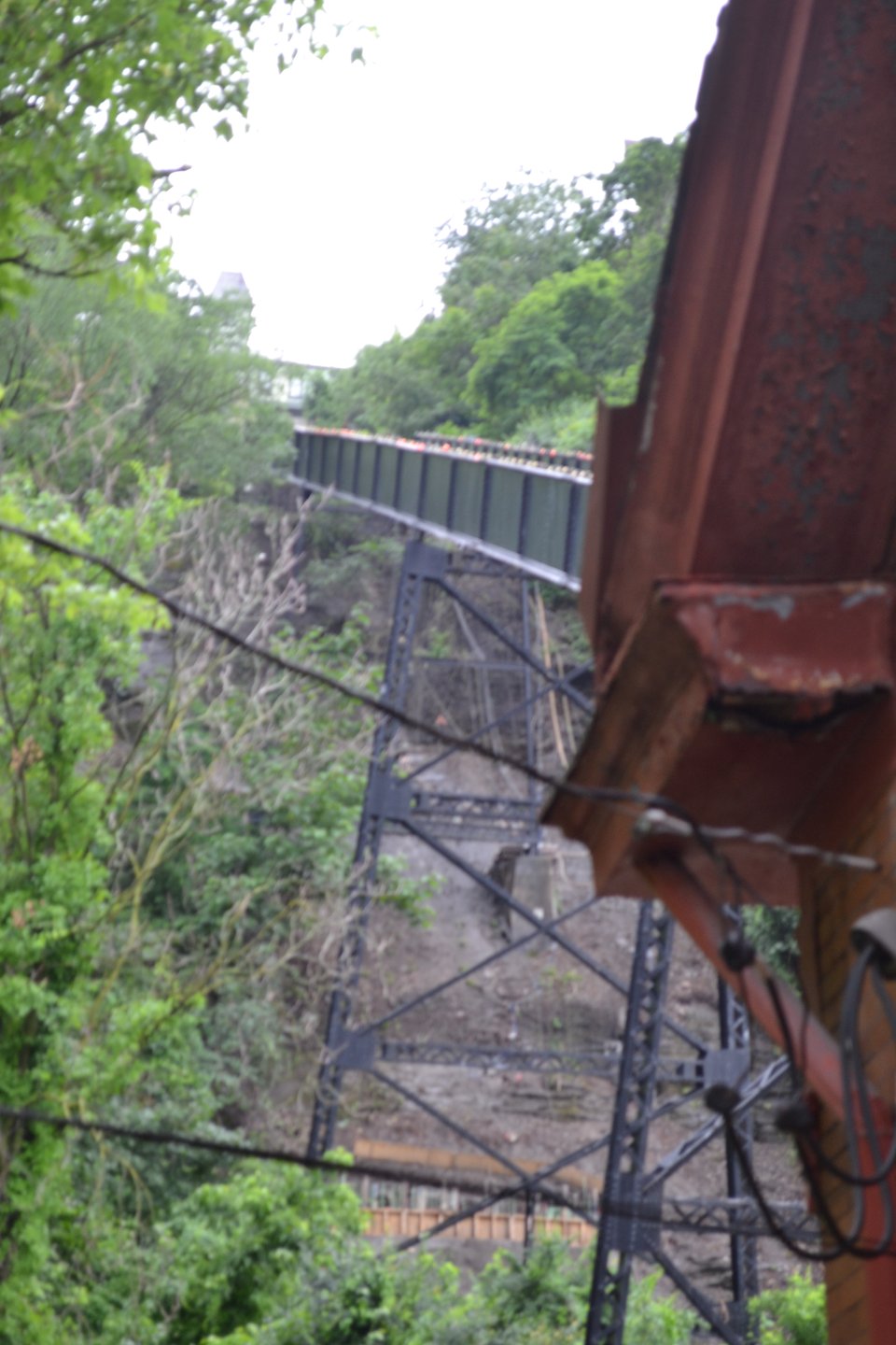 An incline track supported by metal trestles as it runs up a cliff.