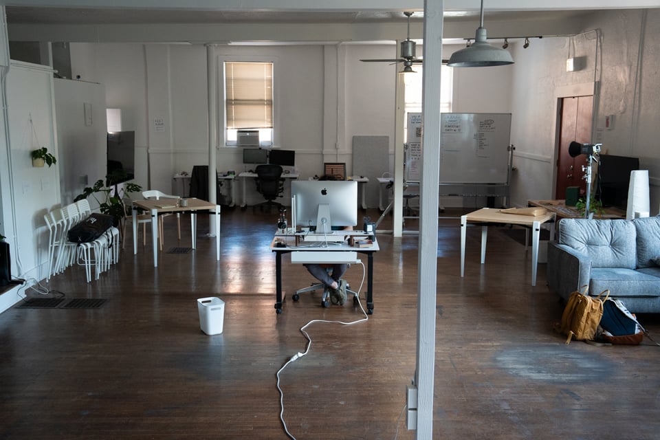 A lone desk in the middle of a room.