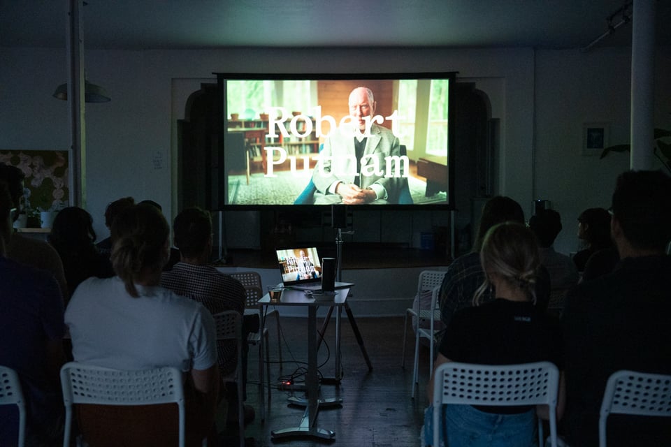 A group of people watching a film.