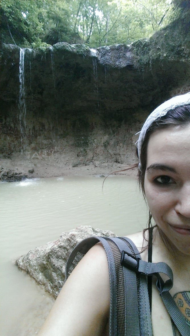 Selfie of Destiny in front of a small waterfall