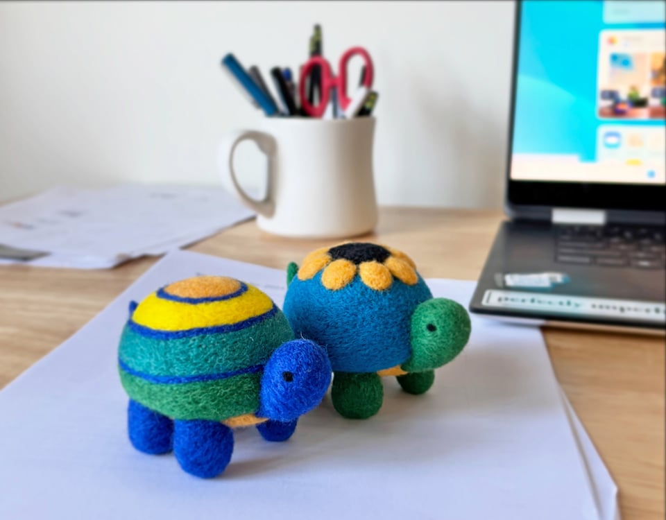 adorable needle-felted turtles on a desk