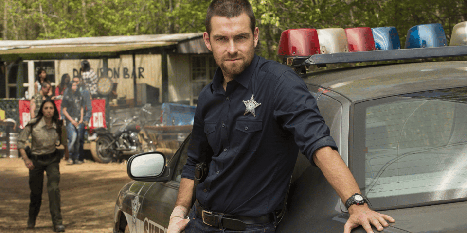 Antony Starr is giving "hard man" and dressed as a sheriff.