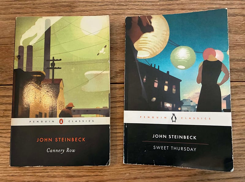Photo of two books by John Steinbeck, Cannery Row and Sweet Thursday, sitting on my dining room table. The copy of Cannery Row is way older but for some reason Sweet Thursday is much more beat up. Probably because I took it to work a couple of times in my backpack.