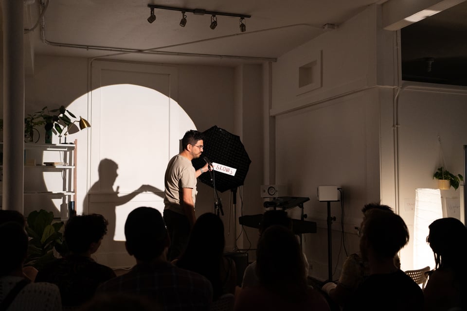 Justin holds up a piece of paper to a small crowd.