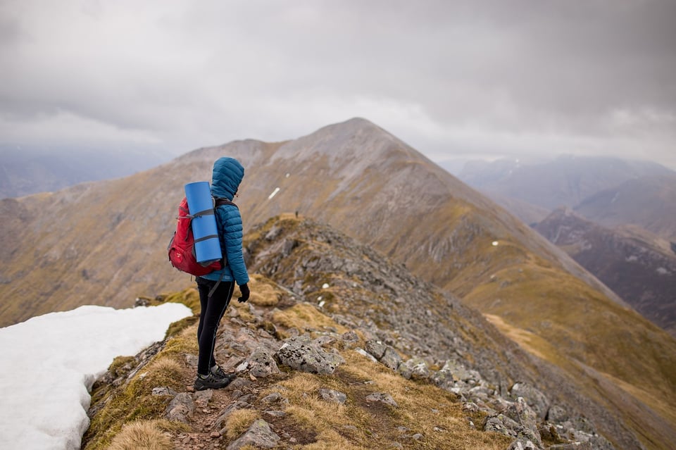 A person standing on top of a mountain.