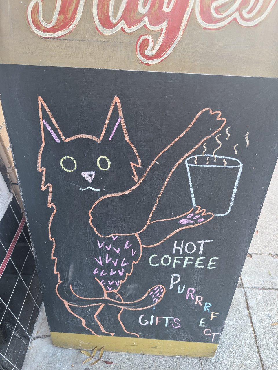 A chalk image of a cat holding a coffee cup and it says Hot Coffee Purrrfect Gifts