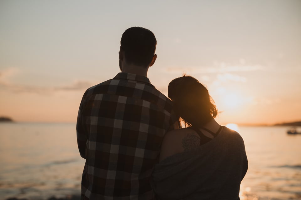 a couple looking at the sunset