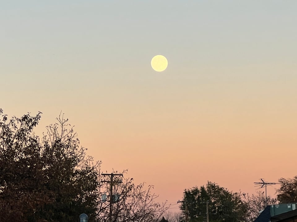 A full moon at sunset