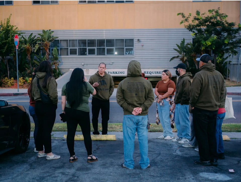 Ron Gochez, a high school teacher, at an early morning meeting in South Central Los Angeles. His organization, Unión del Barrio, doesn’t just document ICE’s operations; it tries to actively disrupt them.