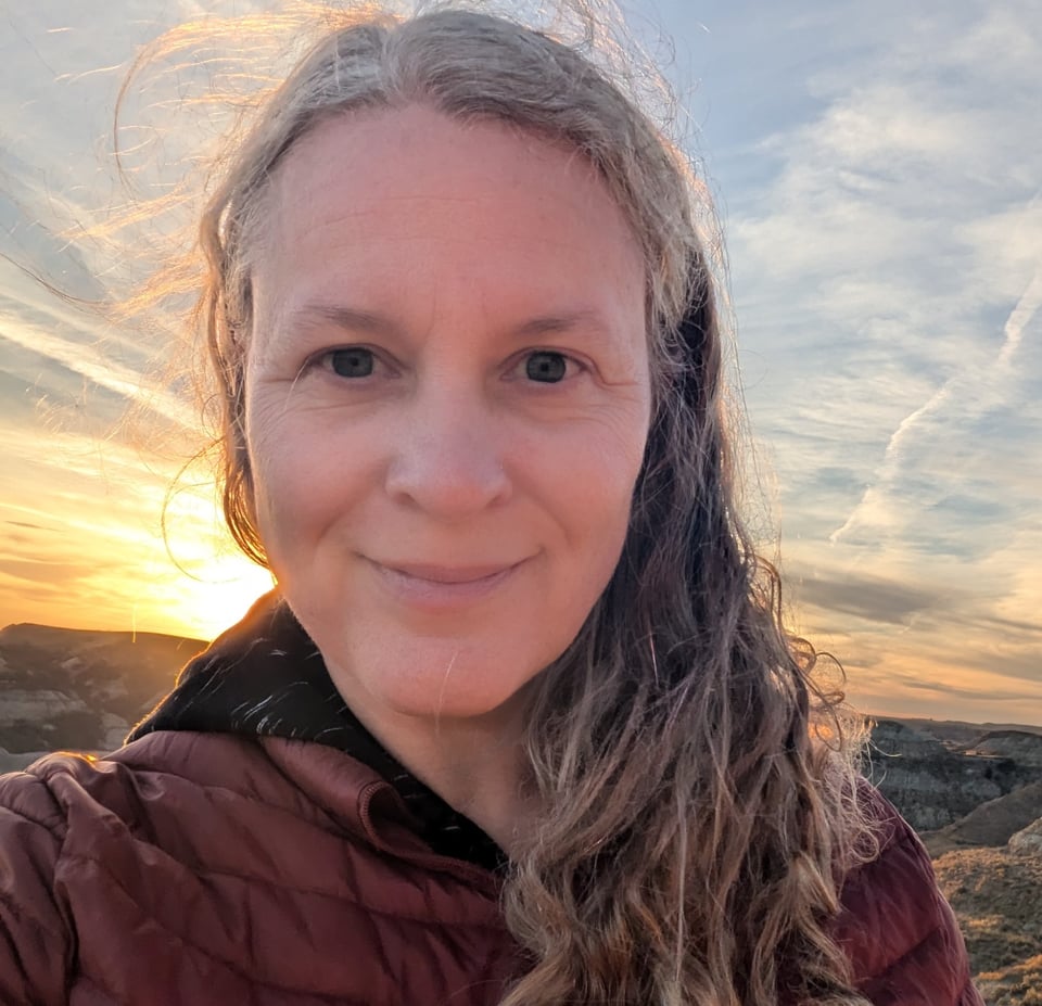 Camille outdoors with the sun setting in the background