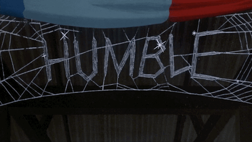 An image from the 1973 movie Charlotte's web: a glistening spider's web with the word "humble" written in silk in the middle.