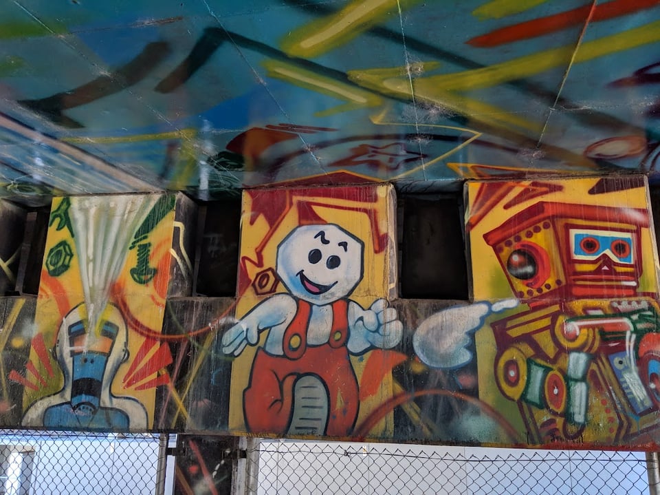 A tryptich of imges, one showing a weird robot, one showing a marshmallow guy in overalls, one showing a slot machine
