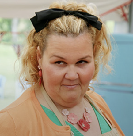 A person with a black bow in her hair looks to the side