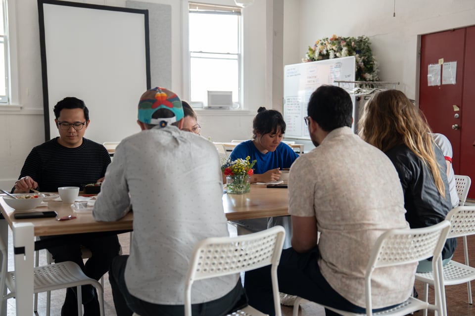 People eating lunch around a table.