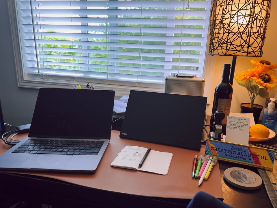 A laptop and portable monitor in use.