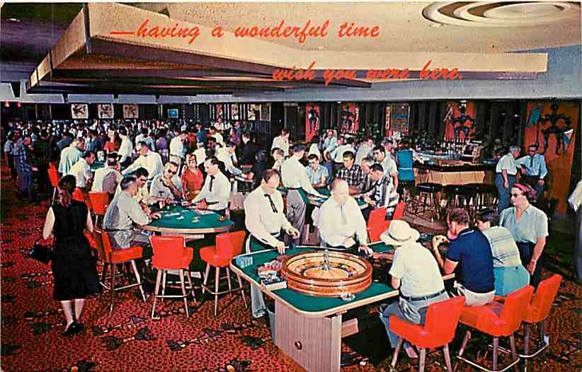 Vintage 60s postcard showing gaming tables at a busy casino.