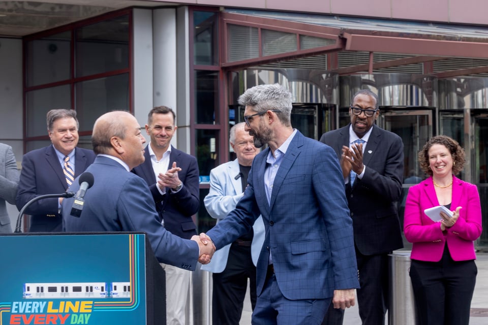 Port Authority Chairman Kevin O'Toole shaking HCCS campaigns manager Jack's hand at PATH press conference